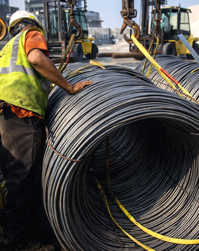 coils of wire being offloaded by stevedores
