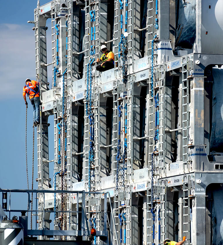 stevedores unloading wind turbine components from barge